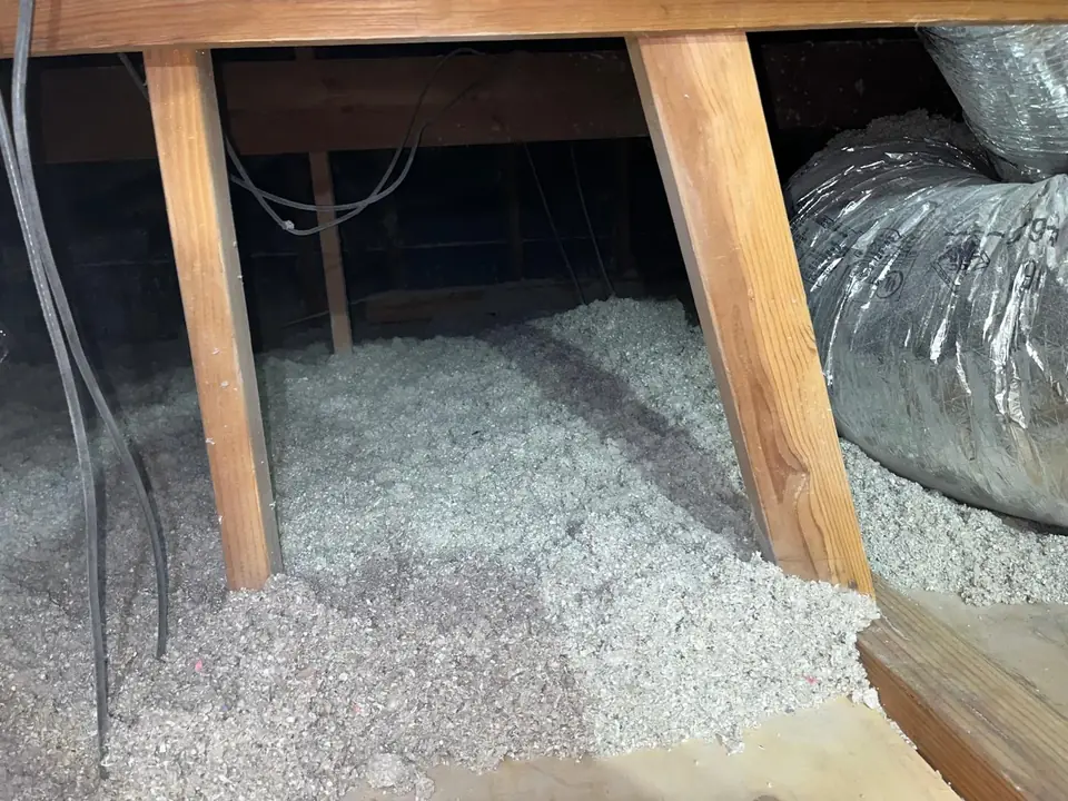 Clean attic with fresh insulation between the joists and new ducts