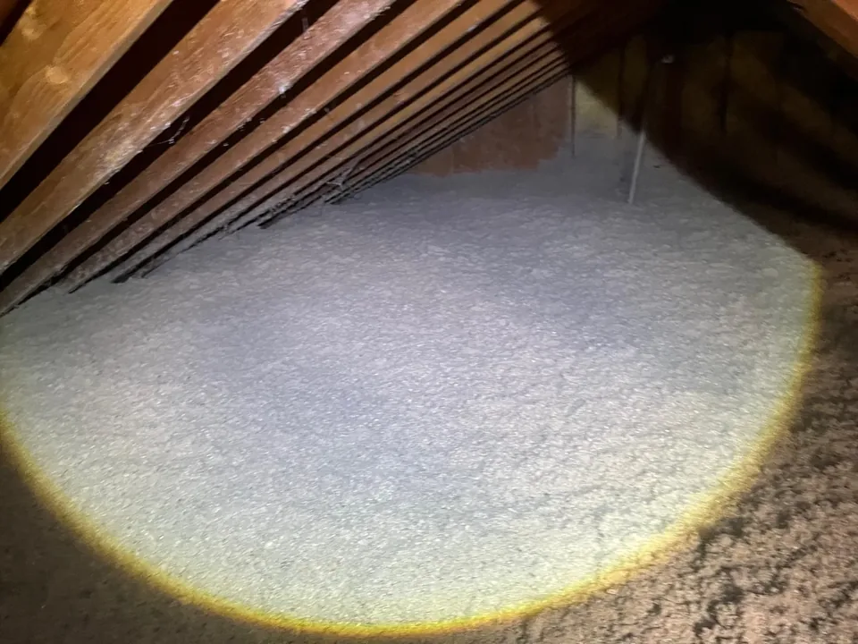 Close view of an even layer of gray blown-in cellulose insulation