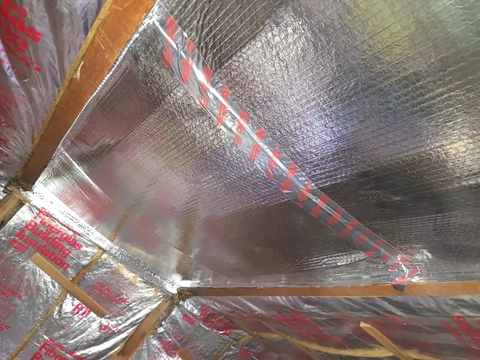 Reflective radiant barrier foil installed under the roof rafters